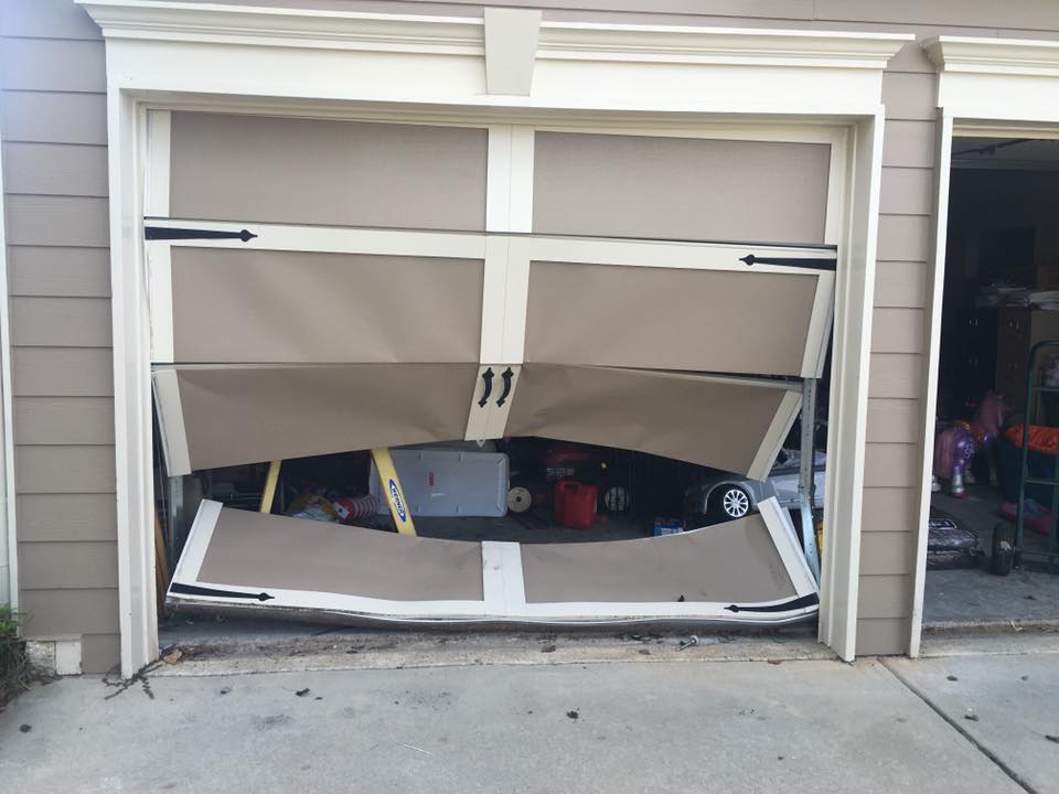 garage door that a car backed into